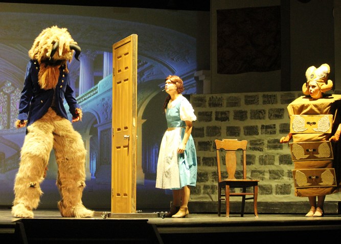 The Beast, Kennedy Charles as Belle with Rachel Peters as Babette looking on.