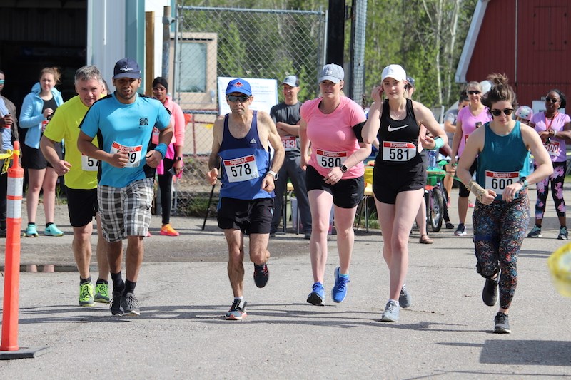 Participants who signed up for the 10-kilometre portion of the inaugural Walk, Bike and Run for the Boreal event take off from the starting line on the morning of June 8.