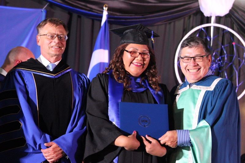 Valedictorian Taylor Flett receives her certificate, degree and diploma from University College of the North president Doug Lauvstad (left) and chancellor Edwin Jebb (right) during the school’s 2019 convocation ceremony in Thompson June 27.