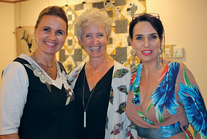 Three friends: Christy Williams, Kerri McFadzean-Main and Dr. Adi Schoeman enjoy Main’s quilt display and visit at her reception in Arts Mosaic Gallery, July 9.