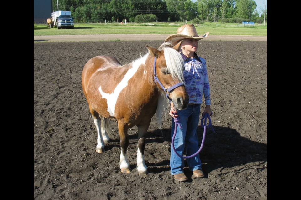 Addie MacKenzie of Nesbitt, Man. and Tuffy wait to be judged in Showmanship 7 years and younger class.