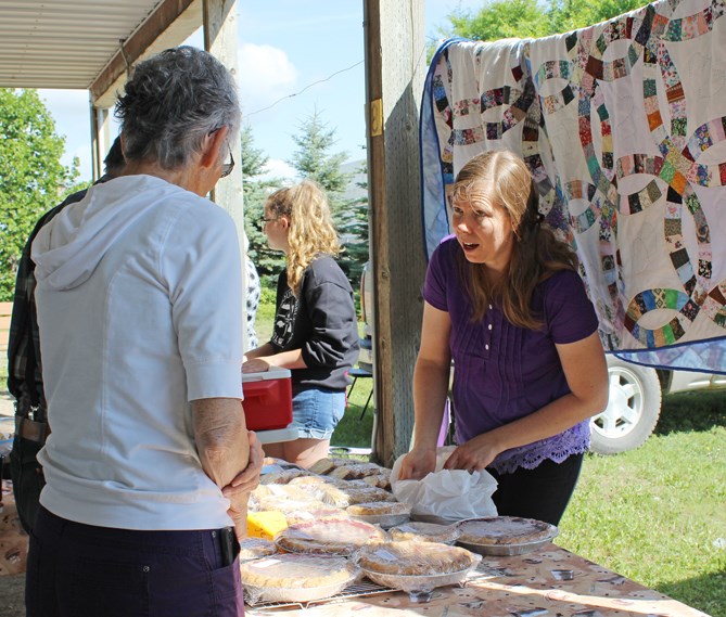 Ruthie Pringle helps customers at her bake table on Friday, July 12 at Virden Farmers Market. Baked goods are her specialty, including pies, cookies, cakes and a small offering of gluten-free baking, too.