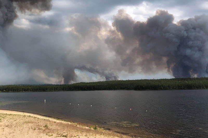Smoke rises from forest fires started by July 24 lightning strikes on the east shore of Burge Lake n