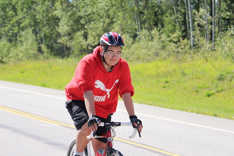 Rayden Seela during the home stretch of his fundraising bike ride from Winnipeg to Thompson, roughly 10 kilometres outside of the Hub of the North on Aug. 22.