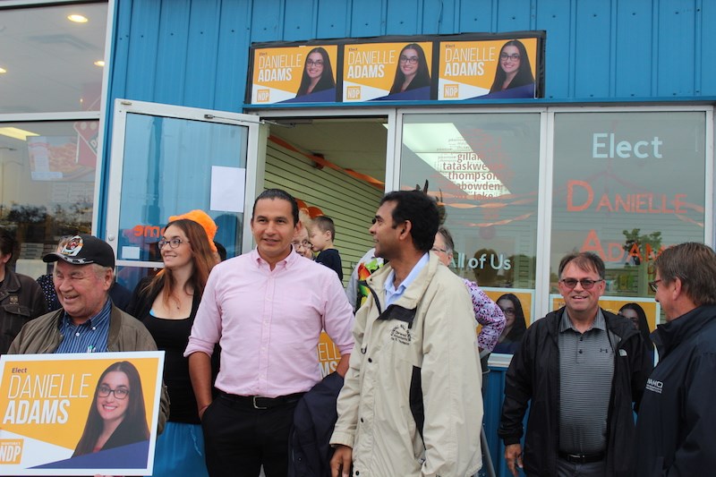 Manitoba NDP leader Wab Kinew poses for a photo with supporters outside of the Danielle Adams' campaign office on Selkirk Avenue Aug. 24.