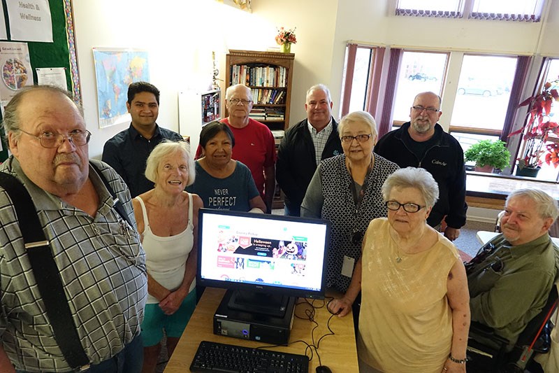 Rotary Place residents pose with computer instructor Kunal Mahajan, back row, left, Rotary Place pro