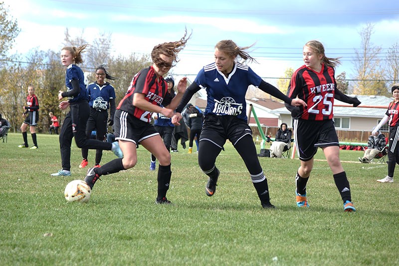 Erica Anderson of R.D. Parker Collegiate’s girls’ soccer team battles for possession against a pair