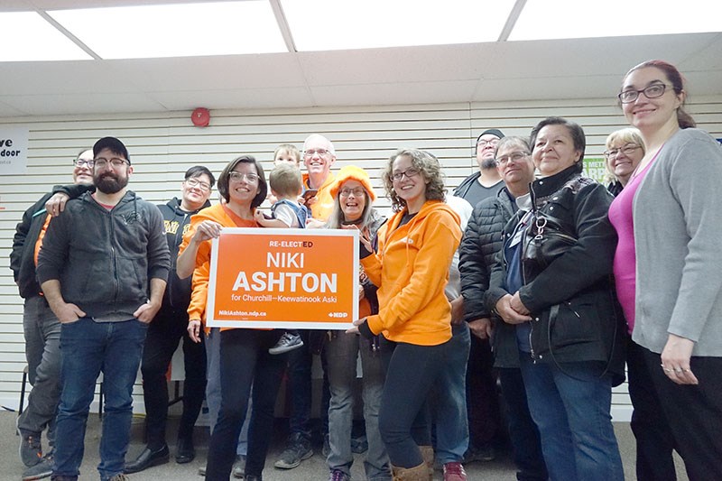 The NDP’s Niki Ashton poses with family and supporters at her campaign office in Thompson after bein