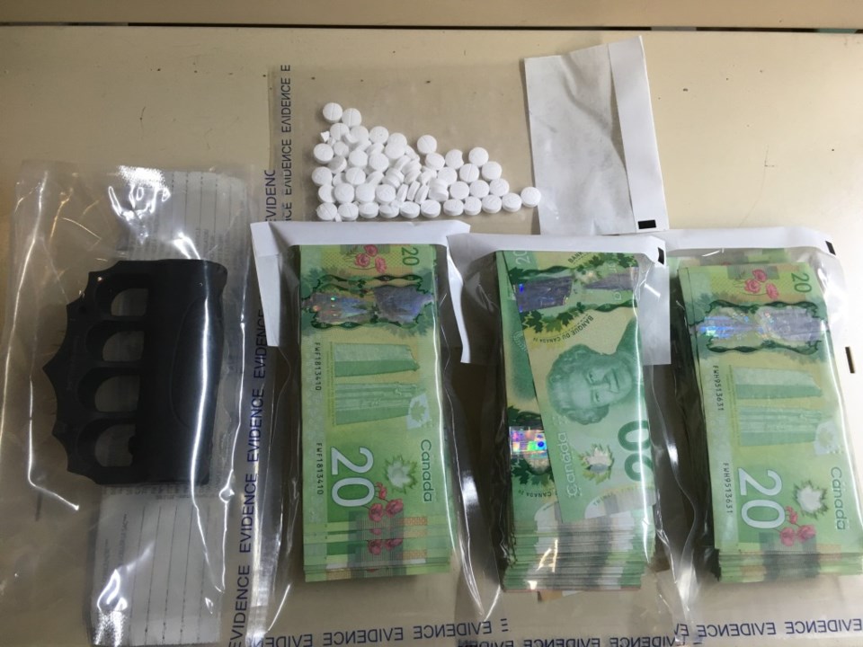 Thompson RCMP seized oxycodone pills, marijuana, cash and a prohibited weapon while searching a resi