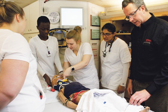 Troy Pauls and four nursing students from Brandon University who are practicing at Virden, are at work to prepare mannequin patient ‘Billy’ for his air ambulance trip.