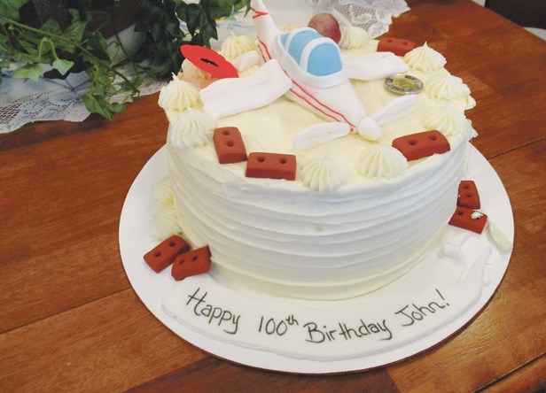 A Piper Cub decorates the 100th birthday cake.