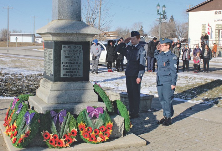 Air cadets McElroy (l) and Bickerton salute at the Elkhorn Cenotaph, Nov. 11.