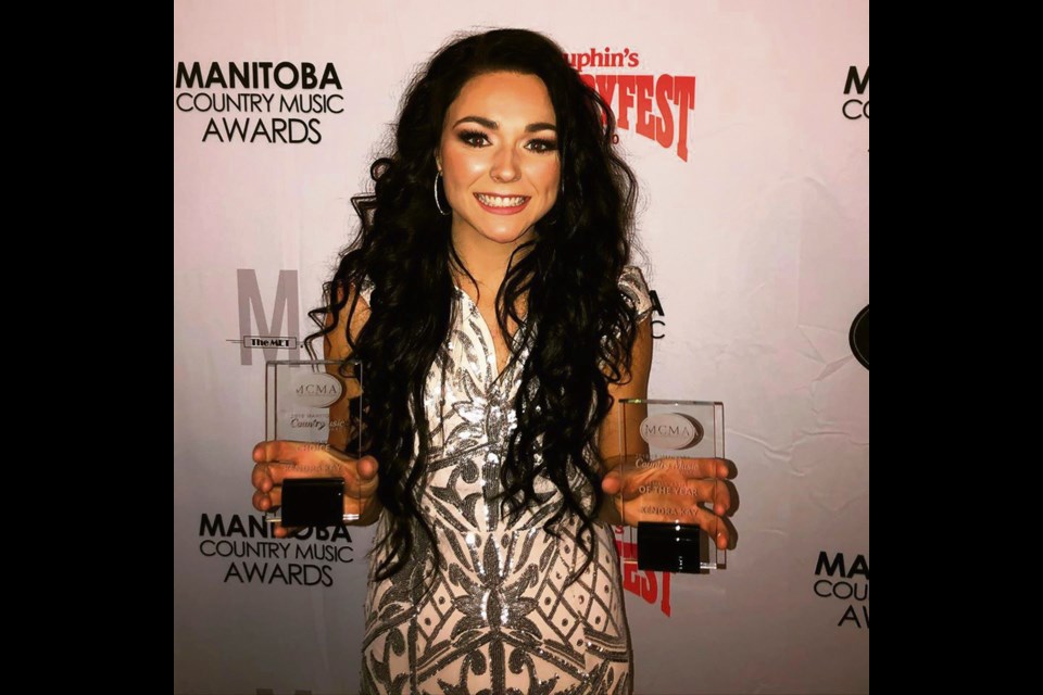 Kendra Kay beams after winning two more country music honours.