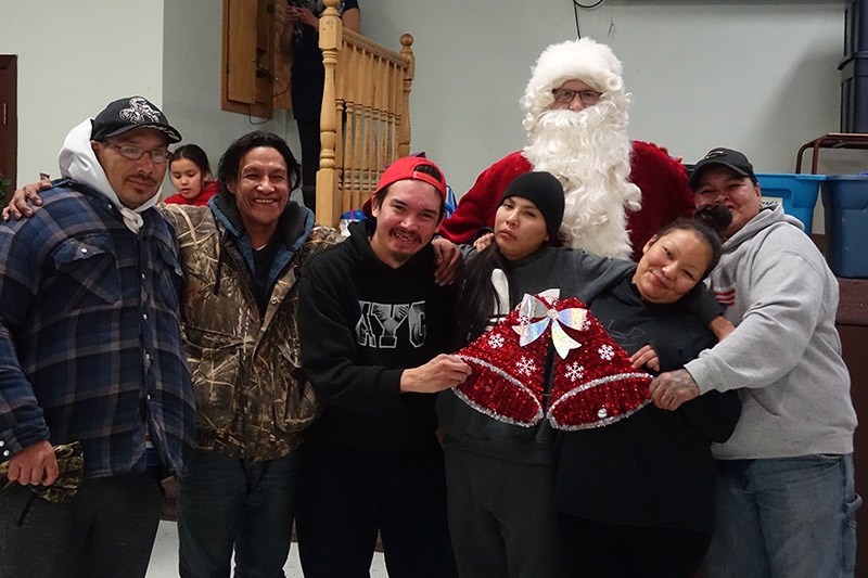 Santa Claus poses with the jigging contest winners from the Nov. 28 Christmas dinner for homeless pe