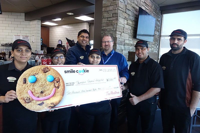Tim Hortons general manager Upendra Patel presents a $2,381 donation to Northern Regional Health Aut