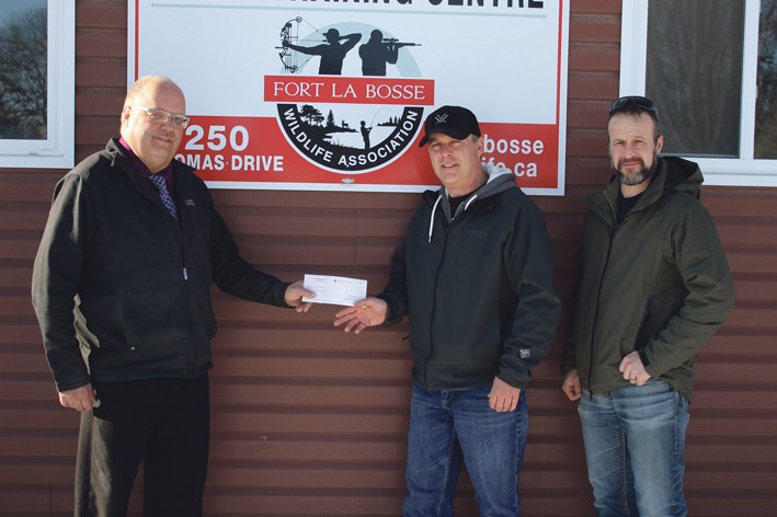 Presenting a donation to Virden Youth Training Centre, on Manager for Loraas Disposal, Brian Wynert hands a cheque for $1,000 to: (l-r) Dale Chadney (Vice-President Fort La Bosse Wild Life Association) and Matt Hipwell (Secretary for FLBWA).