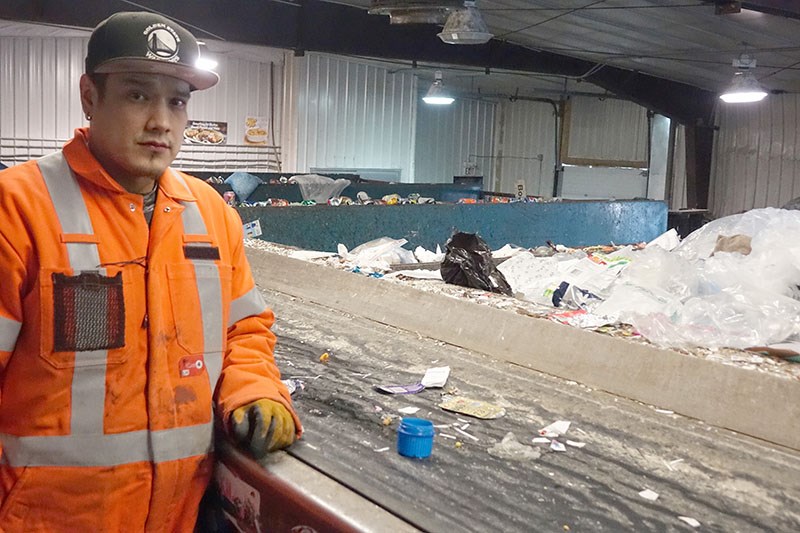 Thompson Recycle Centre employee Aaron Carriere stand by the residential recycling sorting line with