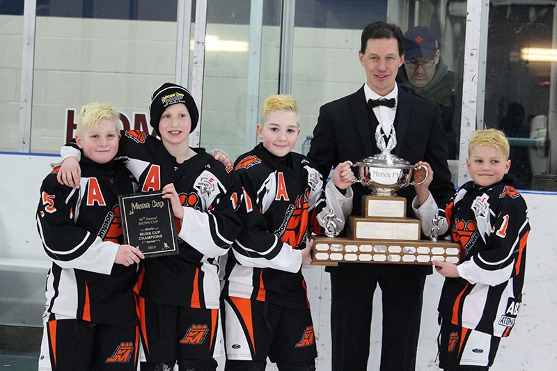 Current Keeper of the Cup Bruce Krentz, seen presenting the Munn Cup to the Thompson King Miners in
