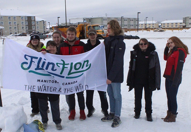 Mayor Colleen Smook raises the Flin Flon flag at Thompson City Hall Feb. 7 after losing a bet with F