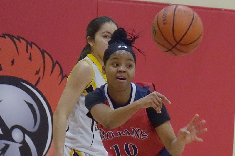 Keashae Masters of R.D. Parker Collegiate’s senior girls’ basketball team dishes the ball during a 5