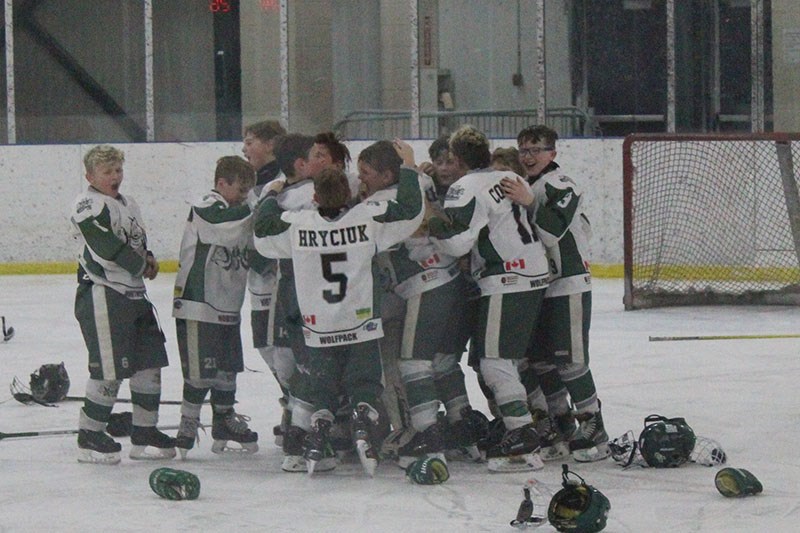 The atom AA North East Wolfpack celebrate after beating the Thompson King Miners 7-3 to win the Munn Cup Feb. 16