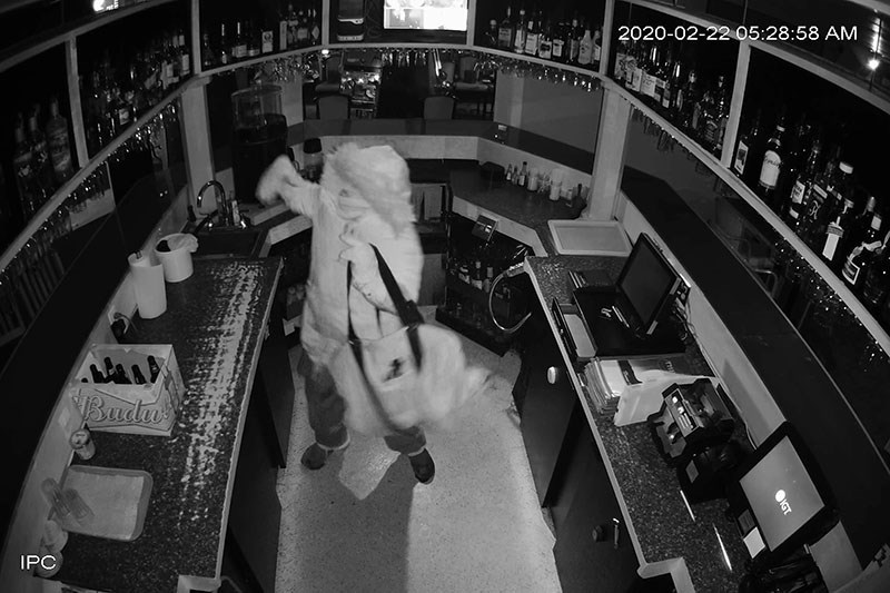 A thief is seen inside The Hub swiping liquor during a break-in Feb. 22.