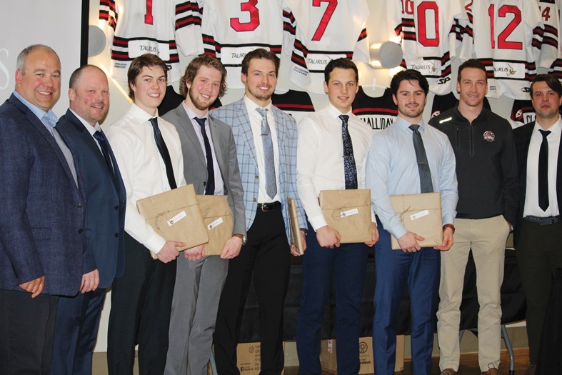 The graduating 20-year-old players will bid farewell to the Oil Caps this spring. During the presentation, Head Coach Tyson Ramsey had words of praise for each of the five graduating players as he introduced them; (l-r) Goaltending coach Ryan Potter, Head Coach Tyson Ramsey, Jaxon Heeney, Darren Gisti, Ethan Peterson, Jayden Wojciechowski and Kolten Kanaski, Assistant Coaches Derek LeBlanc and Reid Gow. Not pictured, Marc Berry Assistant General Manager.