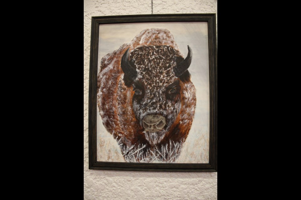 Virden's Marilyn Carruthers' acrylic painting, Winter Bison, hangs in the Westman Centennial Auditorium foyer among some 48 pieces from the Westman area.