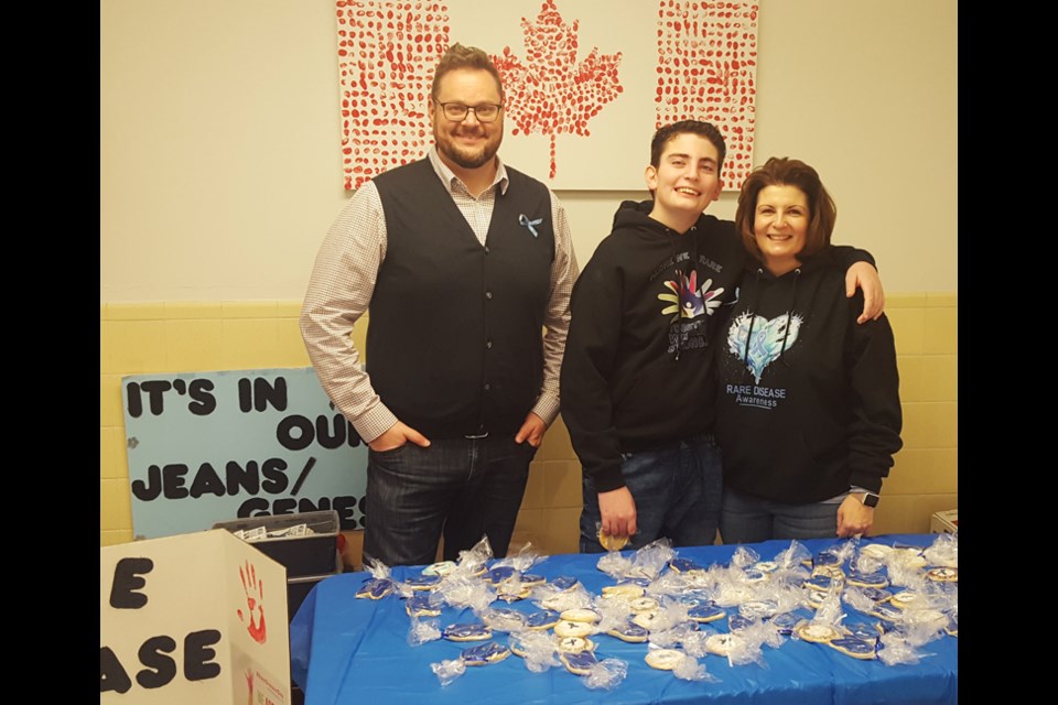 Goulter Principal Will Noseworthy with Cade and Rita Scharff, who visited Goulter on Friday, Feb. 28 selling cookies for Rare Disease Day.