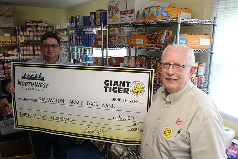 Thompson Giant Tiger manager Cort Guertin, left, provided Roy Bladen of the Salvation Army with a $2