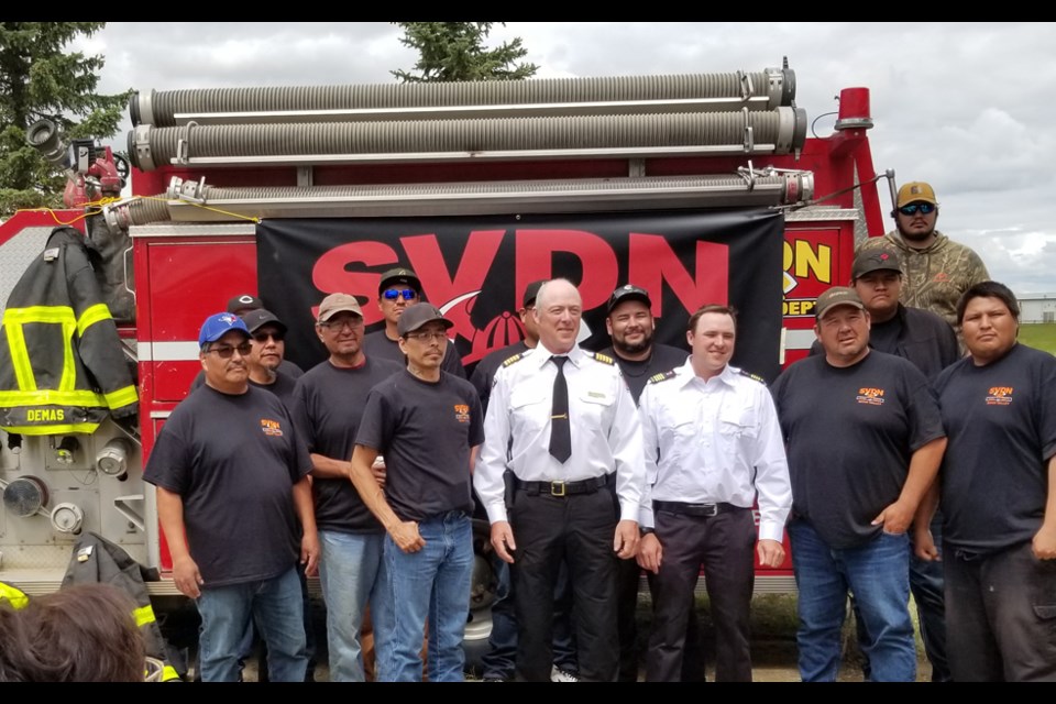 SVDN fire department lined up for a photo with OL-SIfton fire department Chief David Houston (centre) and Deputy Chief Chris Masson.