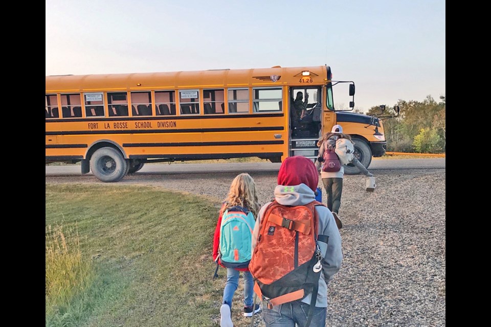Sept. 8 and the first day of school in Fort La Bosse School Division. At a Kola bus stop, the driver gives a wave as the Flannery children head up the lane on Tuesday morning. As the winner of the Empire-Advance Back to School Photo Contest, Becky Flannery takes us right along to the bus with this photo