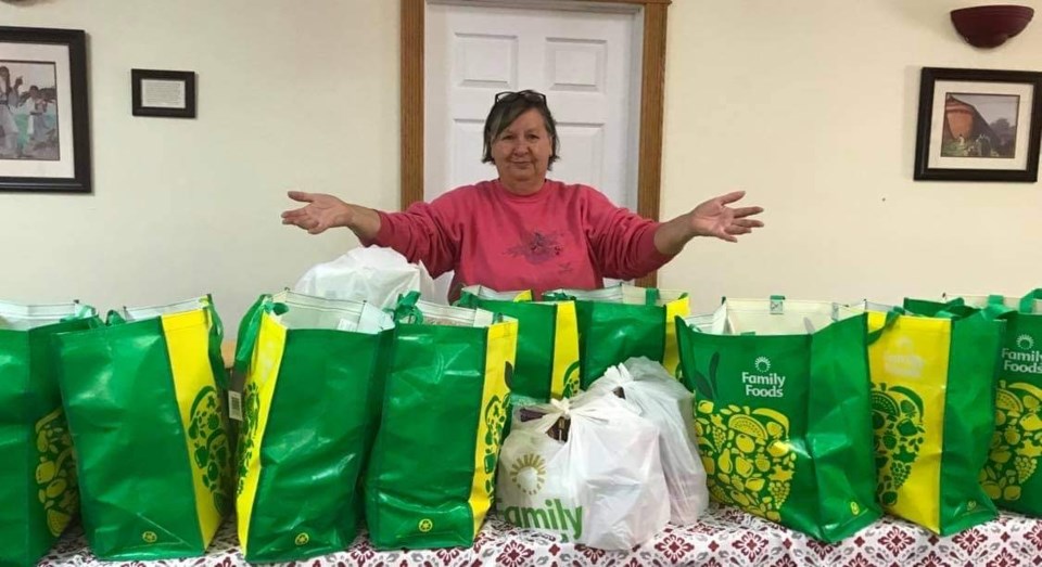 Linda Dearman, chair of the Thompson Seniors Community Resource Council, with bags of groceries that