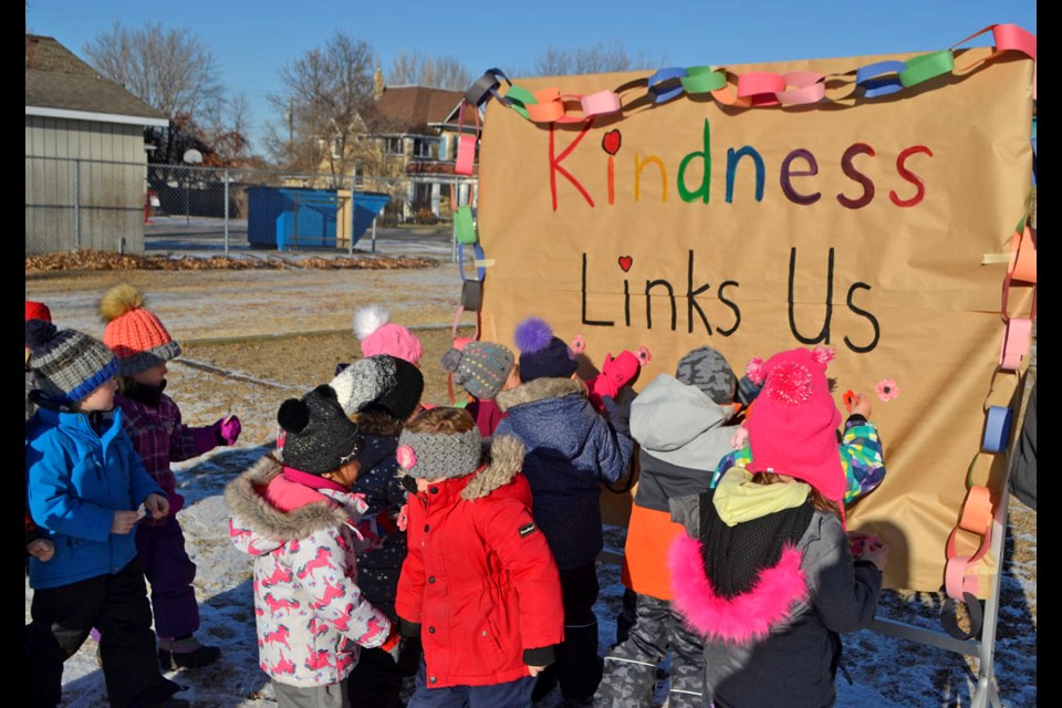 The Kindergarten class is the first to pin poppies on the Mary Montgomery School signboard at their outdoor Remembrance exercise held on Tuesday, Nov. 10. This year's theme: 'Kindness Links Us Together'. As part of Remembrance for the school, each classroom also made a wreath.