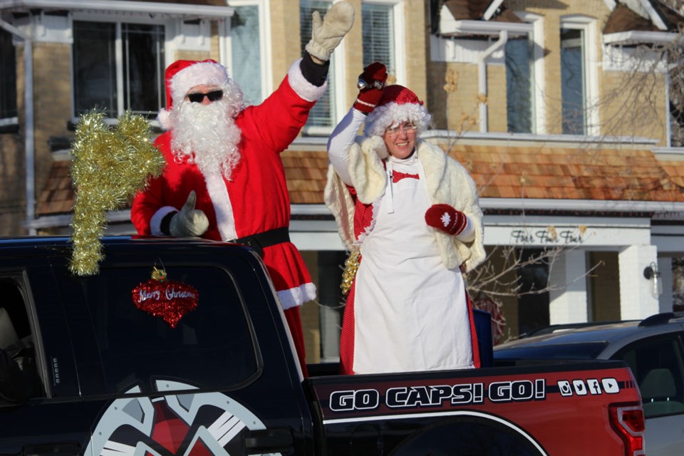 Santa and Mrs. Claus salute school children at Mary Montgomery School Wednesday afternoon.