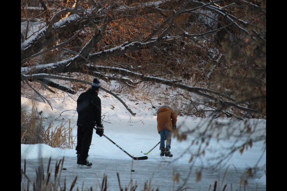 Skaters on Virden’s creek on a warm Dec. afternoon after school in December, hockey sticks in hand, make the most of the retreating daylight.