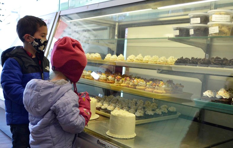 Decorated baked goods draw children to the display case in Sweet Spot Bakery.