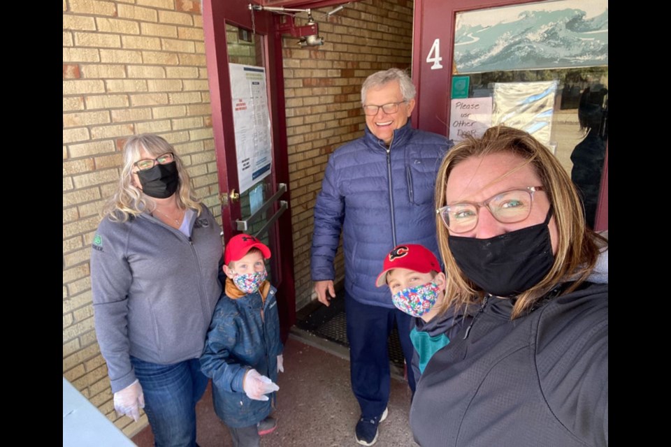 At the doors of the Derrick Theatre on free popcorn Friday, March 26:Councillor for the RM of Wallace-Woodworth Diana MacDonald and her grand-children; Laurel Lamb for PWR ; Rick Slater, owner of the Derrick.