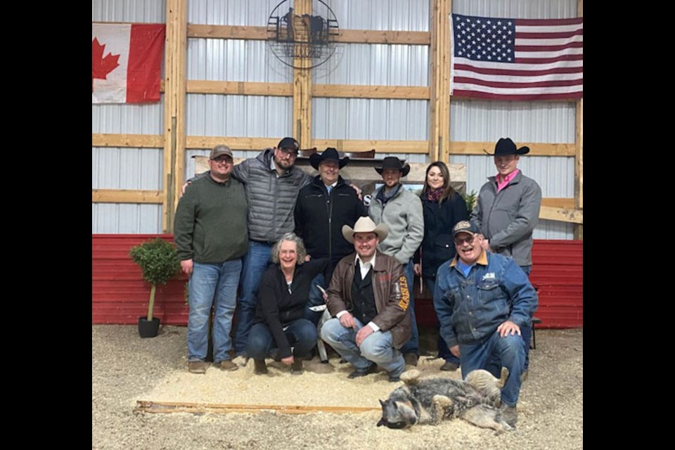 After sale day, Tri-N Charolais owners with Brennan Jack (Jack Auction Group) and sales staff; (Back l) Jesse Nykoliation; Kendra Kvemshagen (Kay) of Elkhorn took care of the office details for Jack Auction; Front (l -r) Joanne Nykoliation, Brennan Jack, Merv Nykoliation and cattle dog Wrangler.