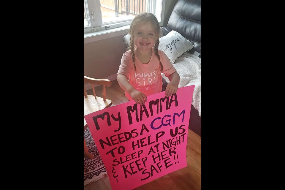 Virden resident Victoria Lelond's daughter, Ava-Joy Lelond, age 3, with her sign "My mamma needs a CGM to help us sleep at night and keep her safe". They attended the Legislature event this week.