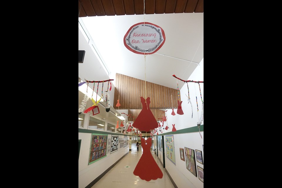 Artwork created by Westwood School Grade 2 students who just completed a weeklong project focusing on missing and Murdered Indigenous Women and Girls hangs in the hallway outside the school’s office.