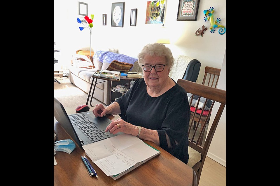 Evergreen Place columnist Helen Martens at work on her laptop, captured on camera by a friend.