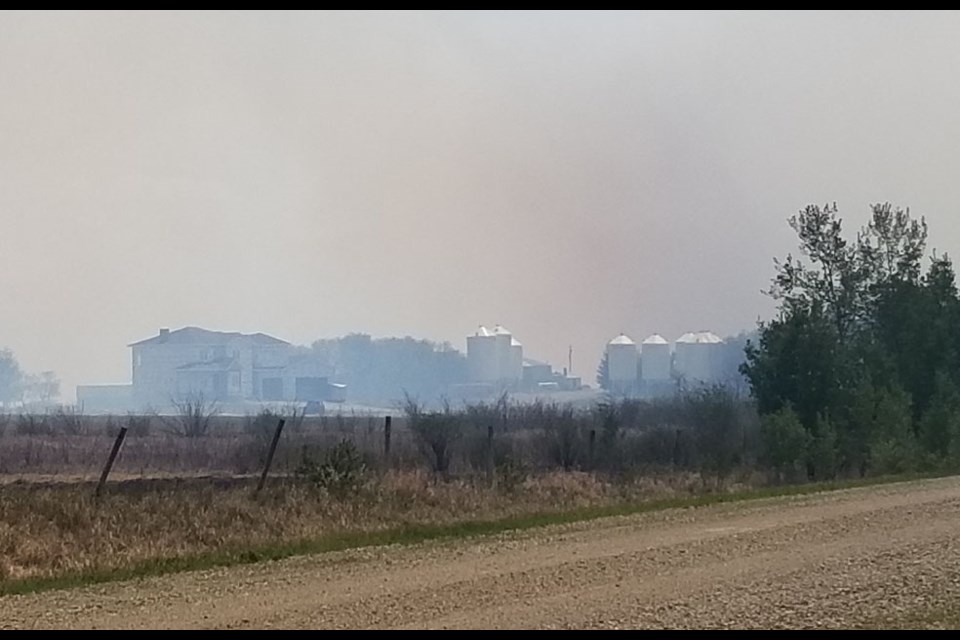 This farm, engulfed in smoke, was down wind of the fire, which never reached the yard. It was controlled by mutual aid firefighters from Miniota Fire Department along with Hamiota Fire Department.