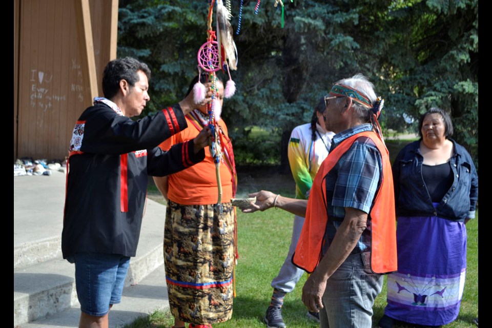 Elder Gabriel Siouxtou leads participants of the Walk of Sorrow in a traditional smudge ceremony at Victoria Park prior to their departure from Virden, June 20.