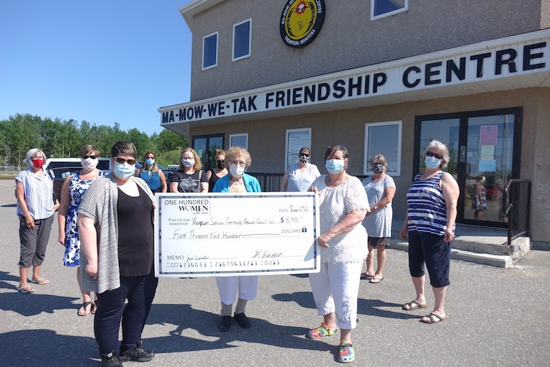 Thompson Seniors Community Resource Council chair Linda Dearman, right, accepts a $5,900 cheque from