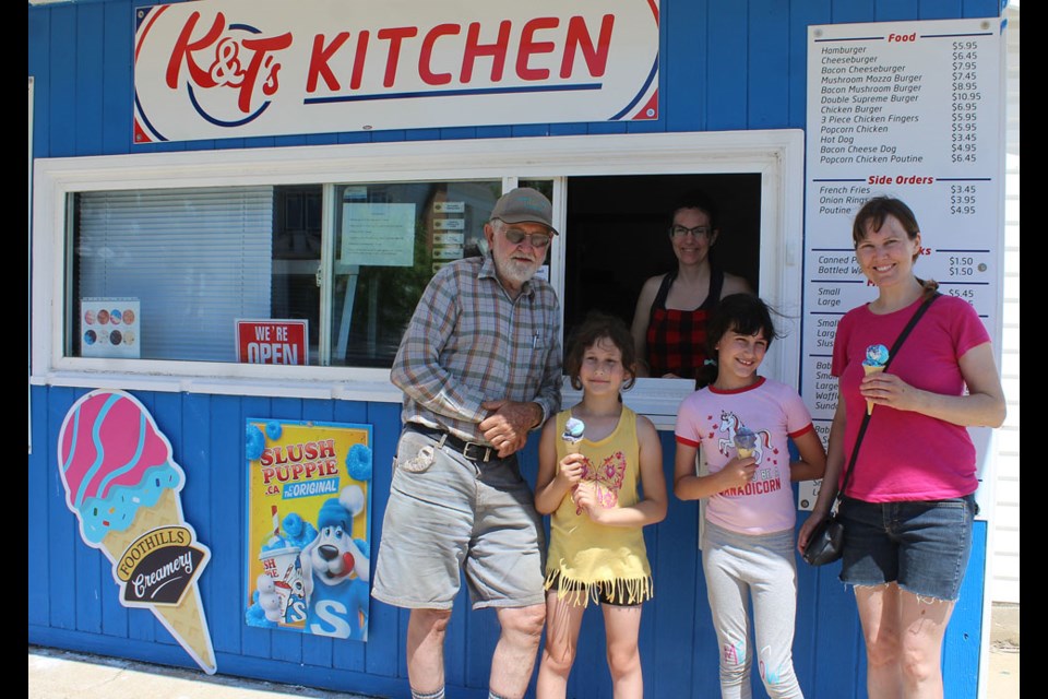 Shown here are Lloyd Warnica and his grand children and daughter having a Canada Day ice cream treat, served by Tamera Bajus at K & T Kitchen.