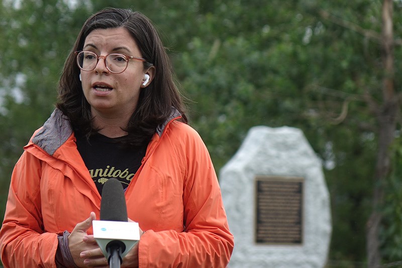 Churchill-Keewatinook Aski NDP candidate Niki Ashton speaks near a monument to residential school su