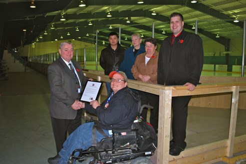 Kristopher Blake, president of People First Thompson Chapter, gives a letter of thanks to John Burrows, director of recreation, parks and culture, left, for the building of a wheelchair ramp in the Gordon Beard arena. Councillors Duncan Wong, Judy Kolada, Colleen Smook, and Dennis Foley also attended the unveiling.