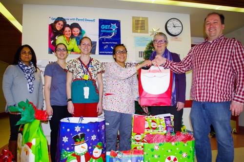 From left to right, Shamilla Thethy, Stephanie Kissick, Shanleigh Anderlik and Maria Antonio, representing the medical, surgical and pediatric unit nurses at the Thompson General Hospital delivered gifts for students to Wapanohk Community School principal Kathleen Kelson and vice-principal Jeff French Dec. 17. Sixteen nurses bought one gift each to help make Christmas merrier for 16 students.