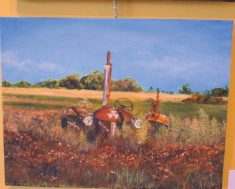 Broken down farm equipment provides a different aspect of time to the paintings seen throughout the exhibit.